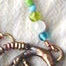 bronze gecko pendant with glass bead accents
