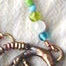 bronze gecko pendant with glass bead accents